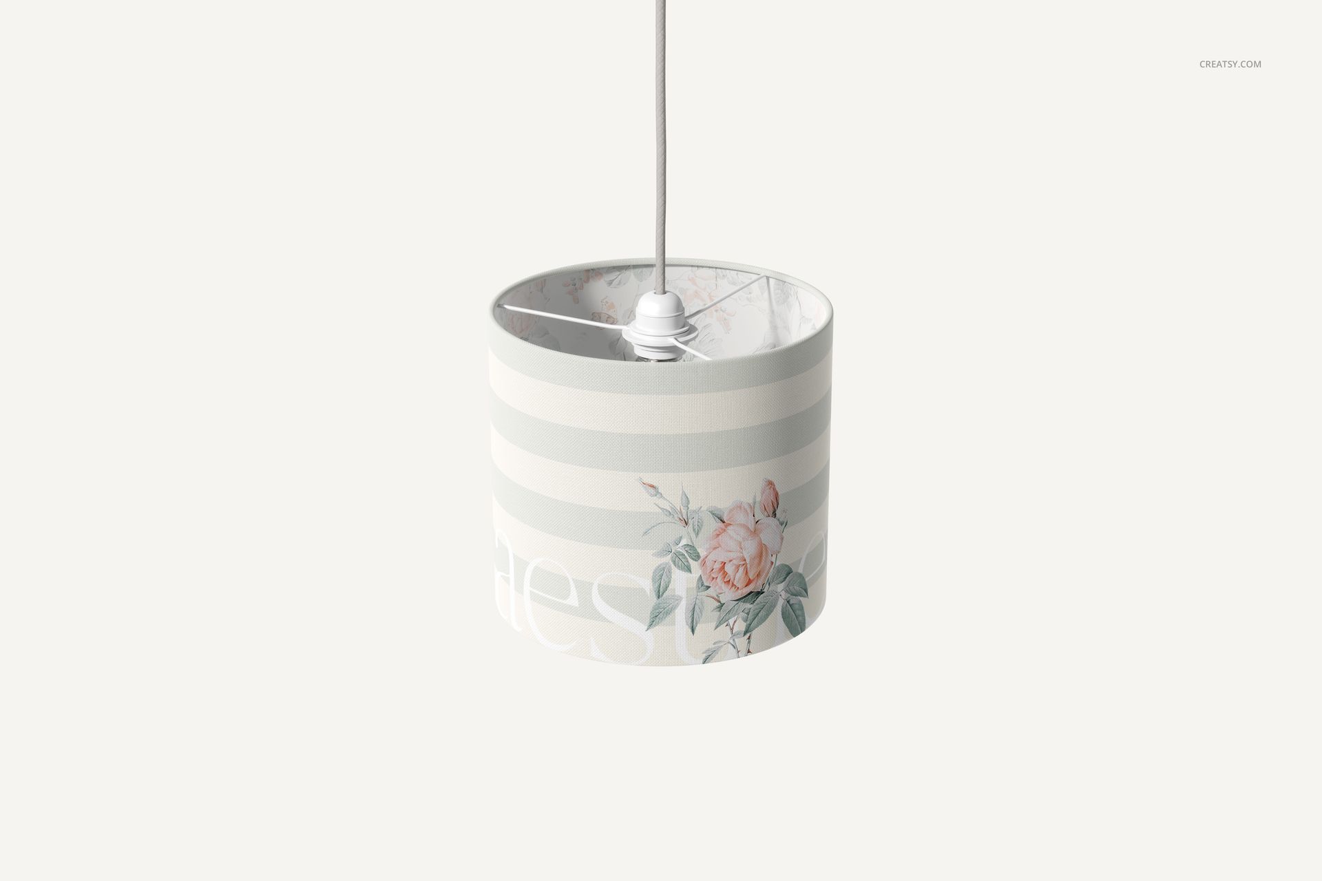 Cylindrical lamp shade mockup displaying horizontal beige stripes and a delicate flower illustration, viewed from the front.