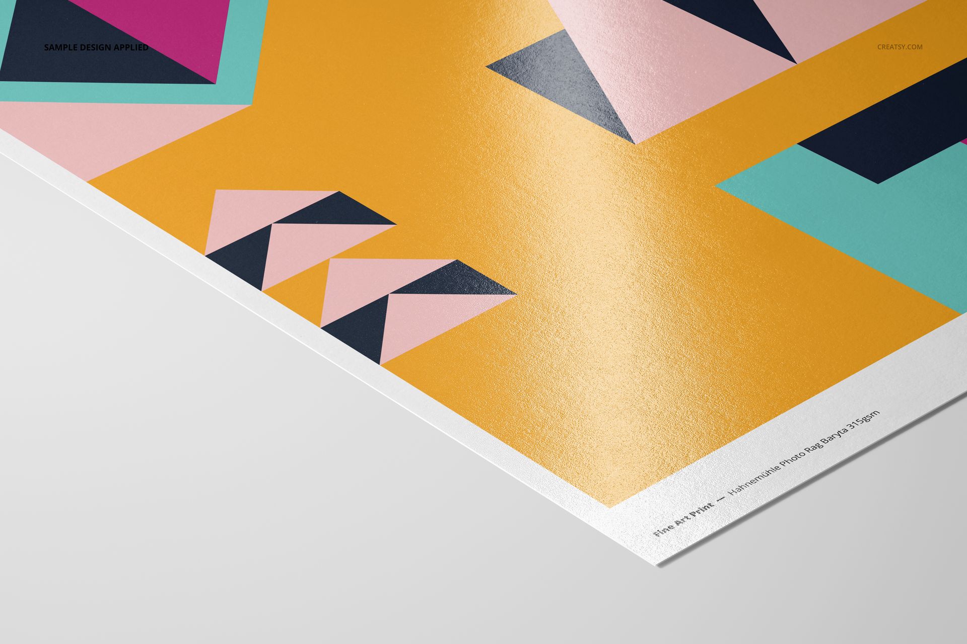 A3 art print mockup showing a glossy paper surface with abstract geometric pattern in bold colors, viewed from an angle.