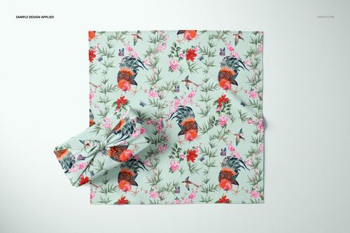 Top view of a Furoshiki fabric wrap mockup featuring a colorful design with flowers and roosters on a pale background.
