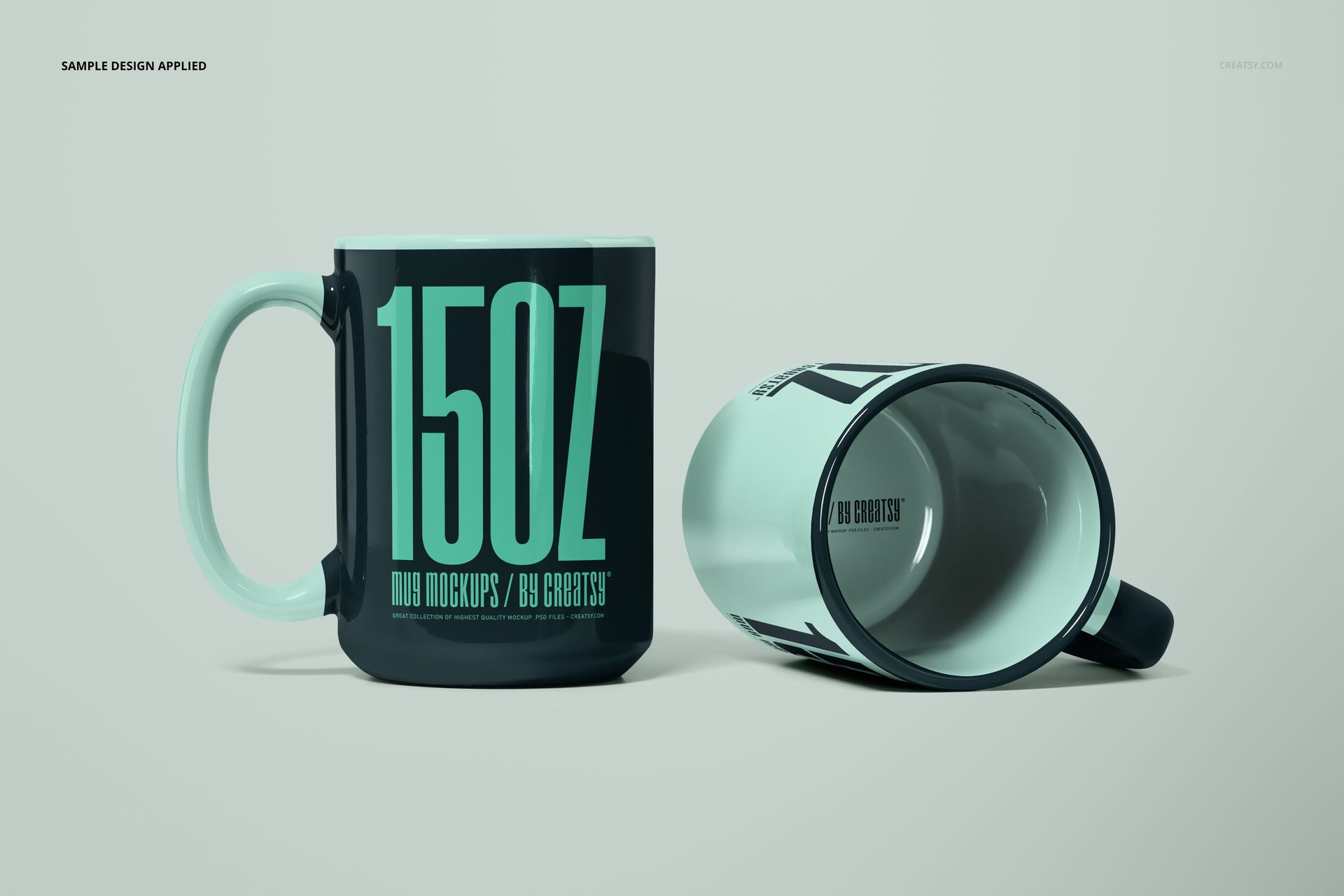 PSD mockup featuring two large mugs, one standing and one tipped over, with teal handles and bold teal text design.