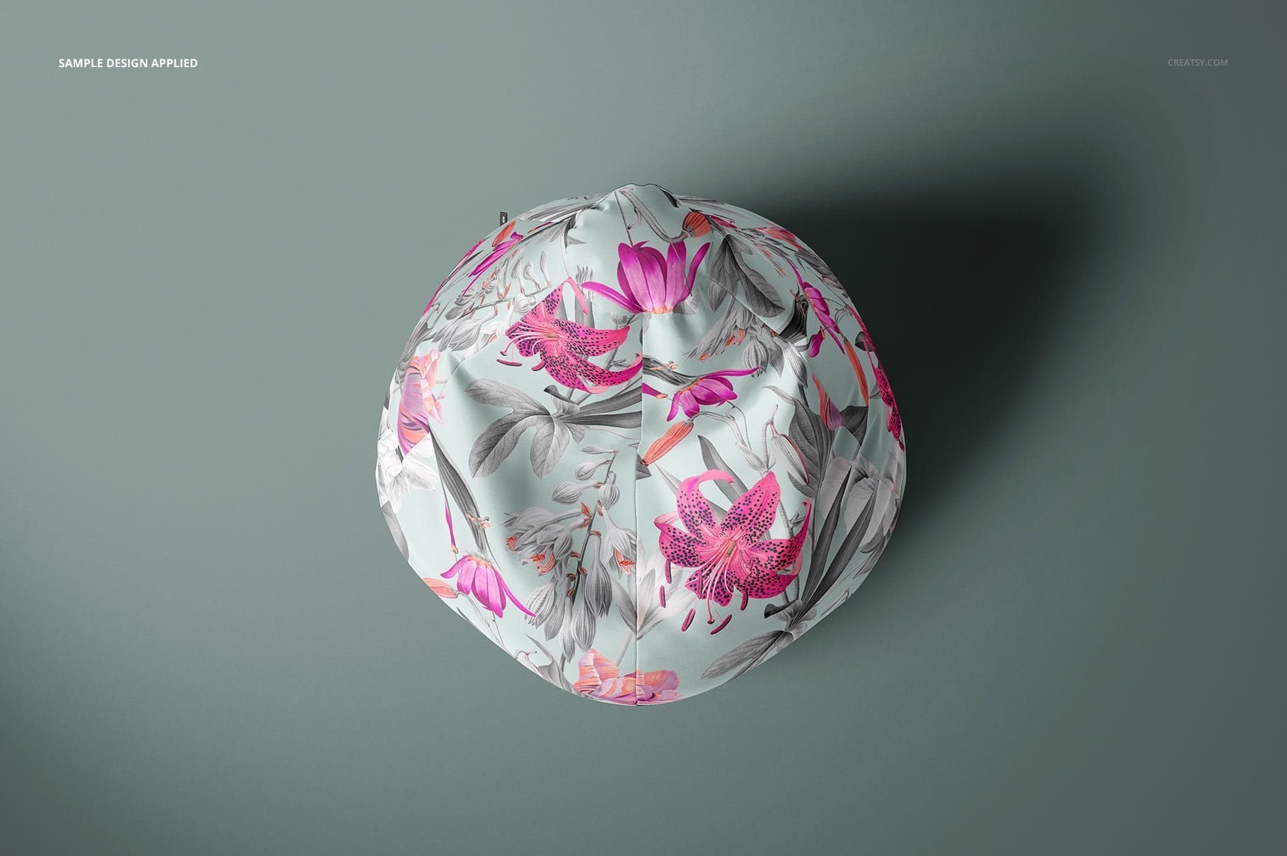 All-over print bean bag chair mockup shown from above, featuring pink and gray botanical designs on a soft gray base.