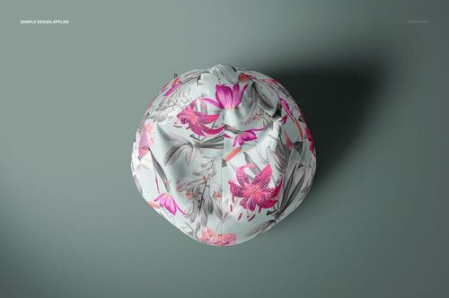 All-over print bean bag chair mockup shown from above, featuring pink and gray botanical designs on a soft gray base.