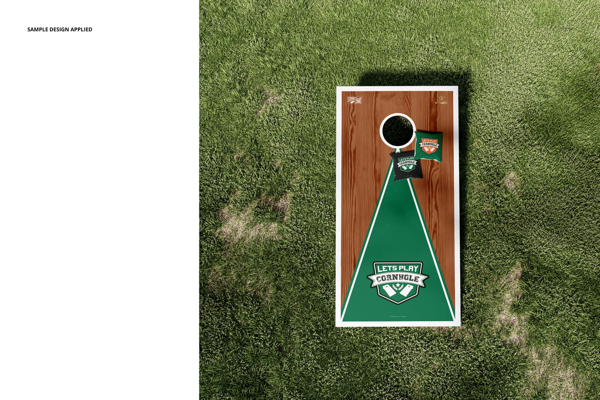 Cornhole board mockup set displayed outdoors on grass, showing a rectangular board with green and wood accents.