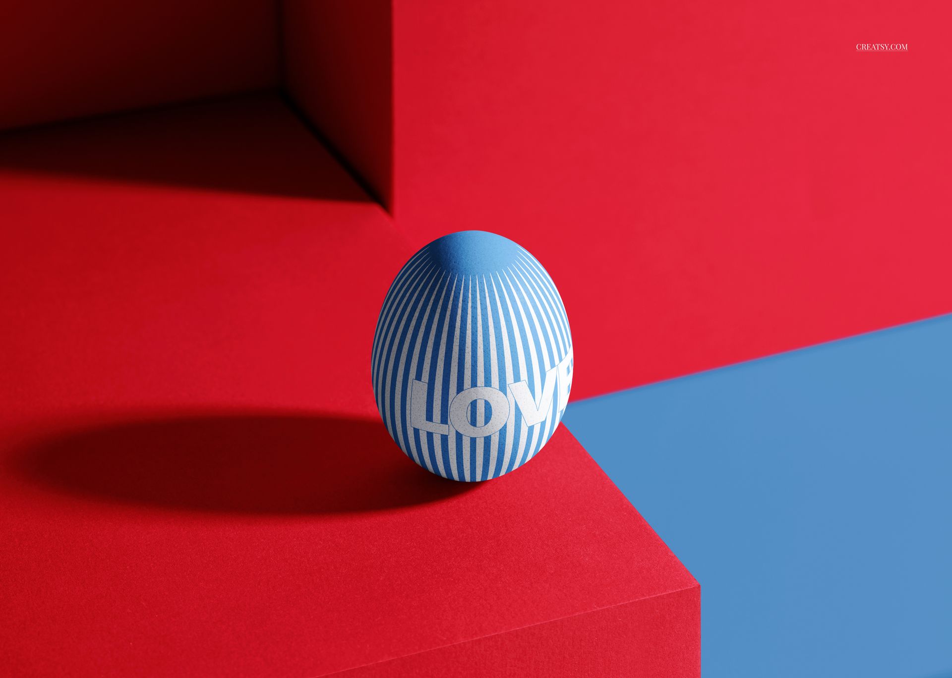 Modern Easter egg mockup featuring a blue egg with white lines and bold lettering, set against red and blue blocks.