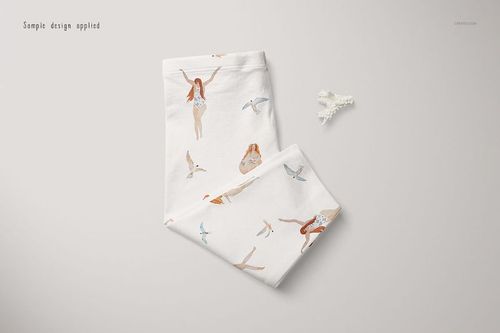 Folded baby leggings mockup featuring whimsical swimmer and bird patterns on a white background, top view.