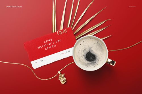 Valentine’s stationery mockup featuring a greeting card with red and white design, cup of coffee, and gold necklace on a red background.