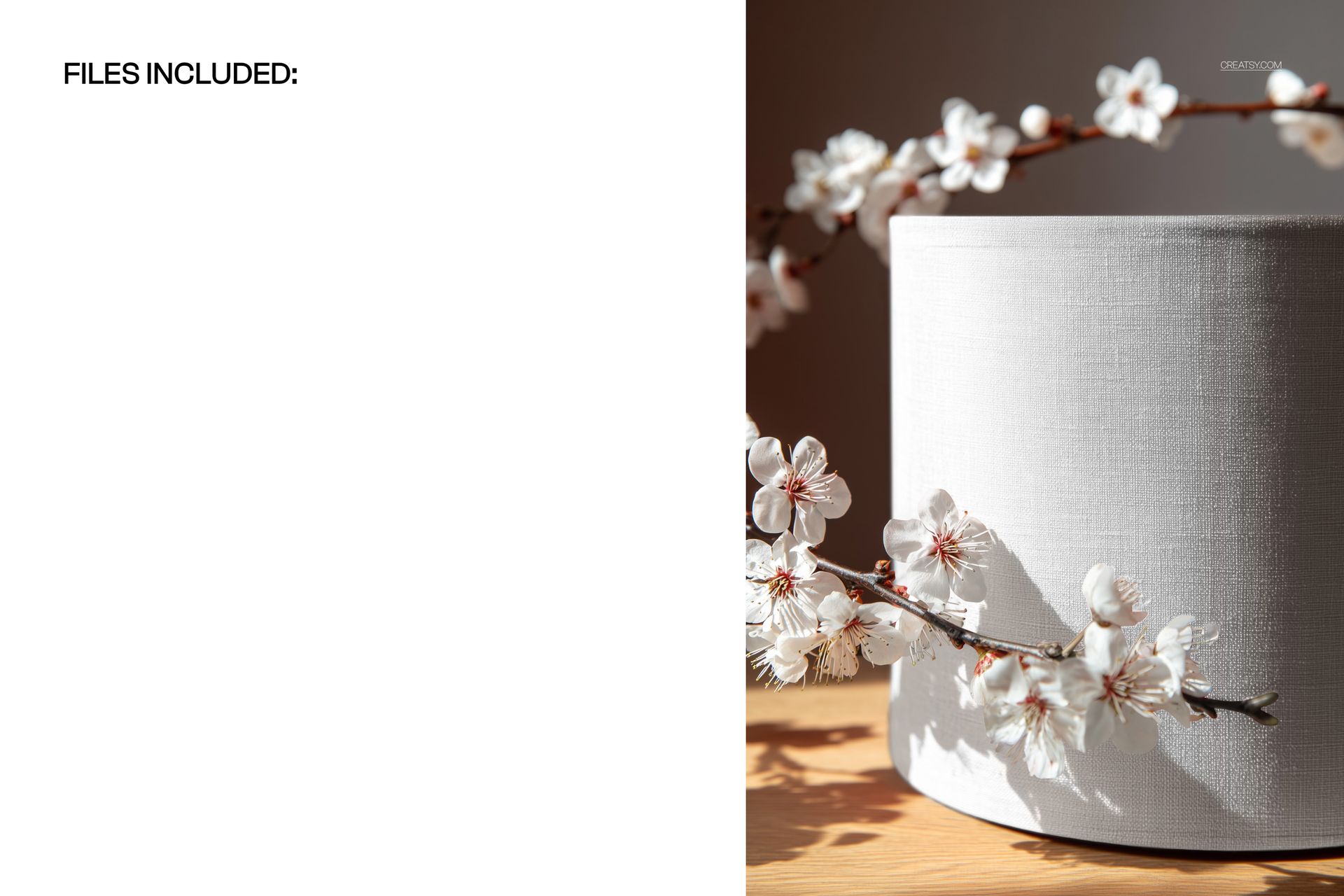 Close-up of a white drum lampshade mockup, featuring a delicate blossom branch in natural light on a wooden surface.