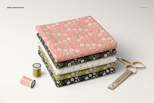 Fabric stack mockup featuring four folded textiles with small floral prints in pastel and dark shades, viewed from the front.