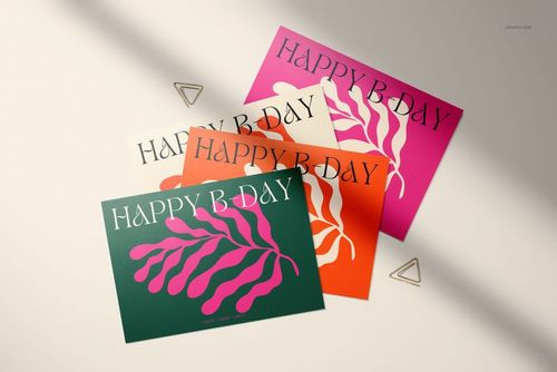 Four 5x7 greeting cards with bold leaf designs and 'Happy B-Day' text, arranged on a light surface with metal clips.
