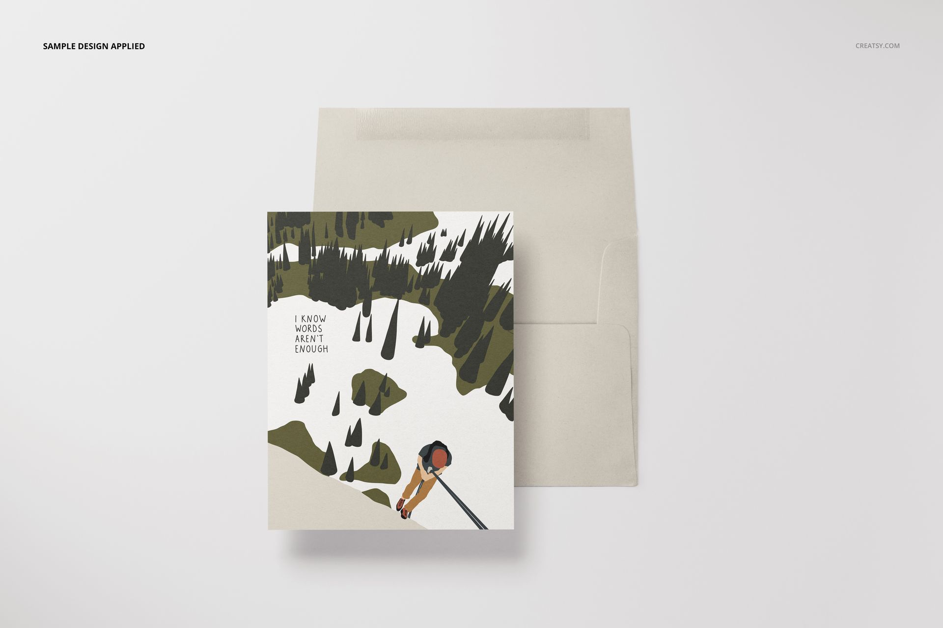 A2 stationery mockup with a card displaying a snowy forest scene and envelope, arranged on a clean white surface.