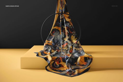 Colorful silk scarf mockup featuring swirling botanical and bird motifs, arranged on a geometric yellow surface, front angle.