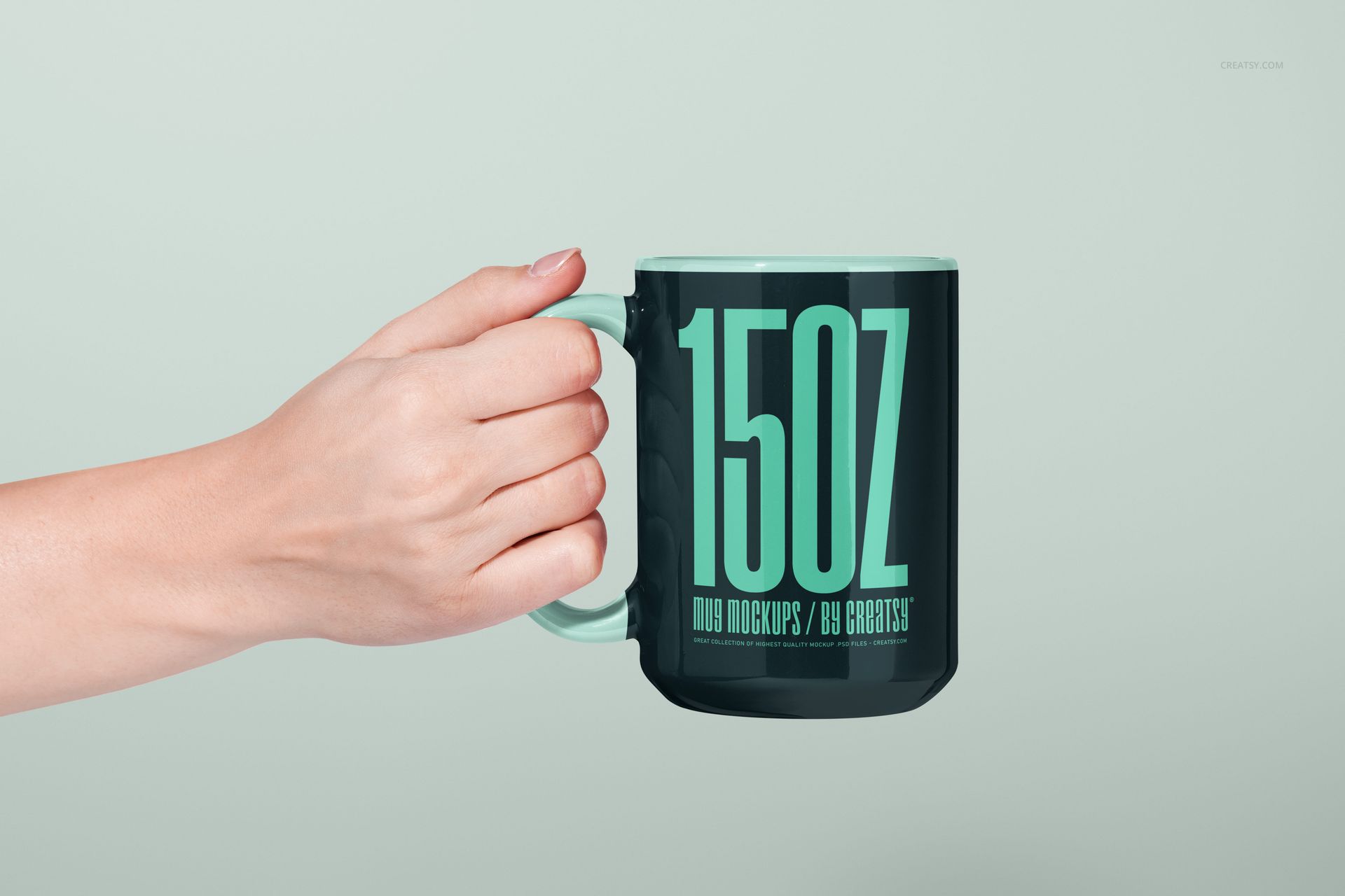 PSD mockup of a 15oz mug featuring a minimal turquoise text print, held by a hand on a pale background.
