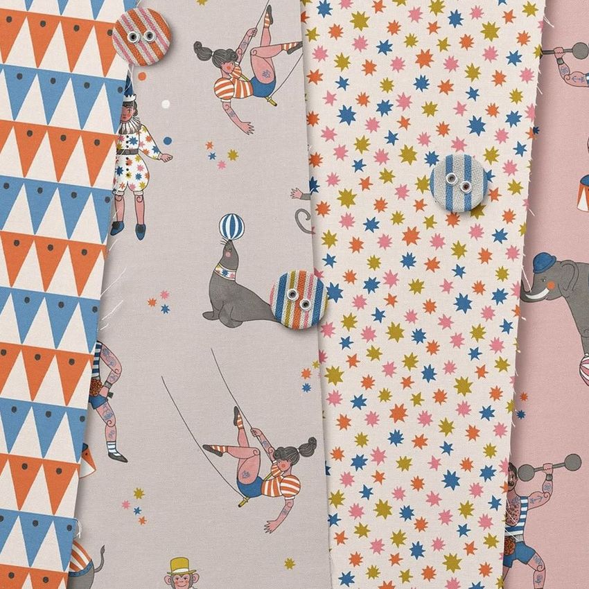 Cotton fabric sample mockup showing four patterned swatches arranged side by side, featuring circus-themed illustrations and geometric designs.