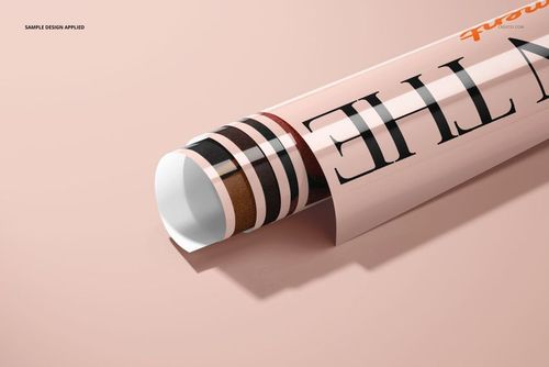 Rolled glossy PVC poster mockup with bold black lettering and brown stripes on a soft pink background, close-up view.