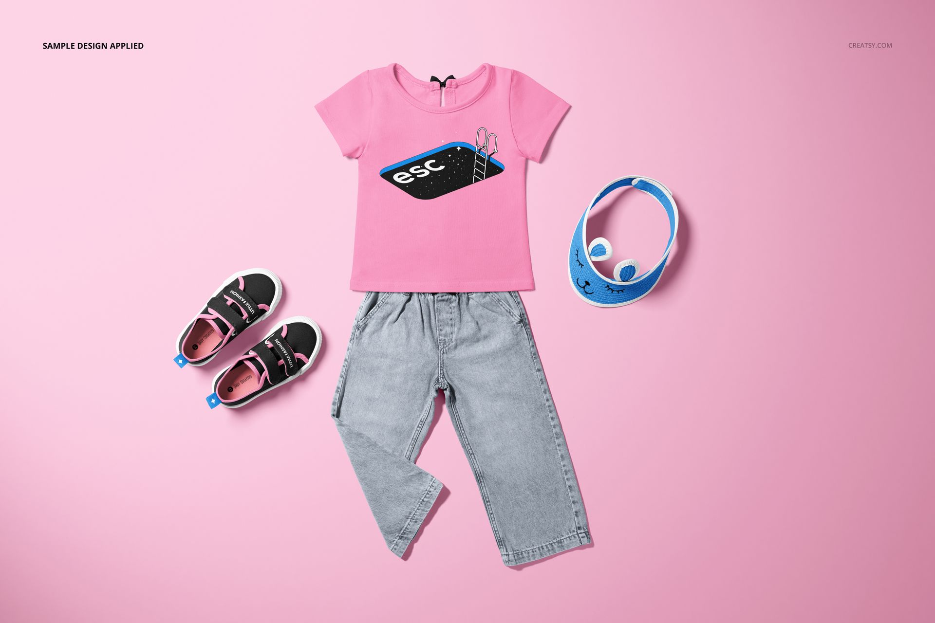 Kids t-shirt and jeans set mockup displayed on a pink background with matching shoes and headphones as props.