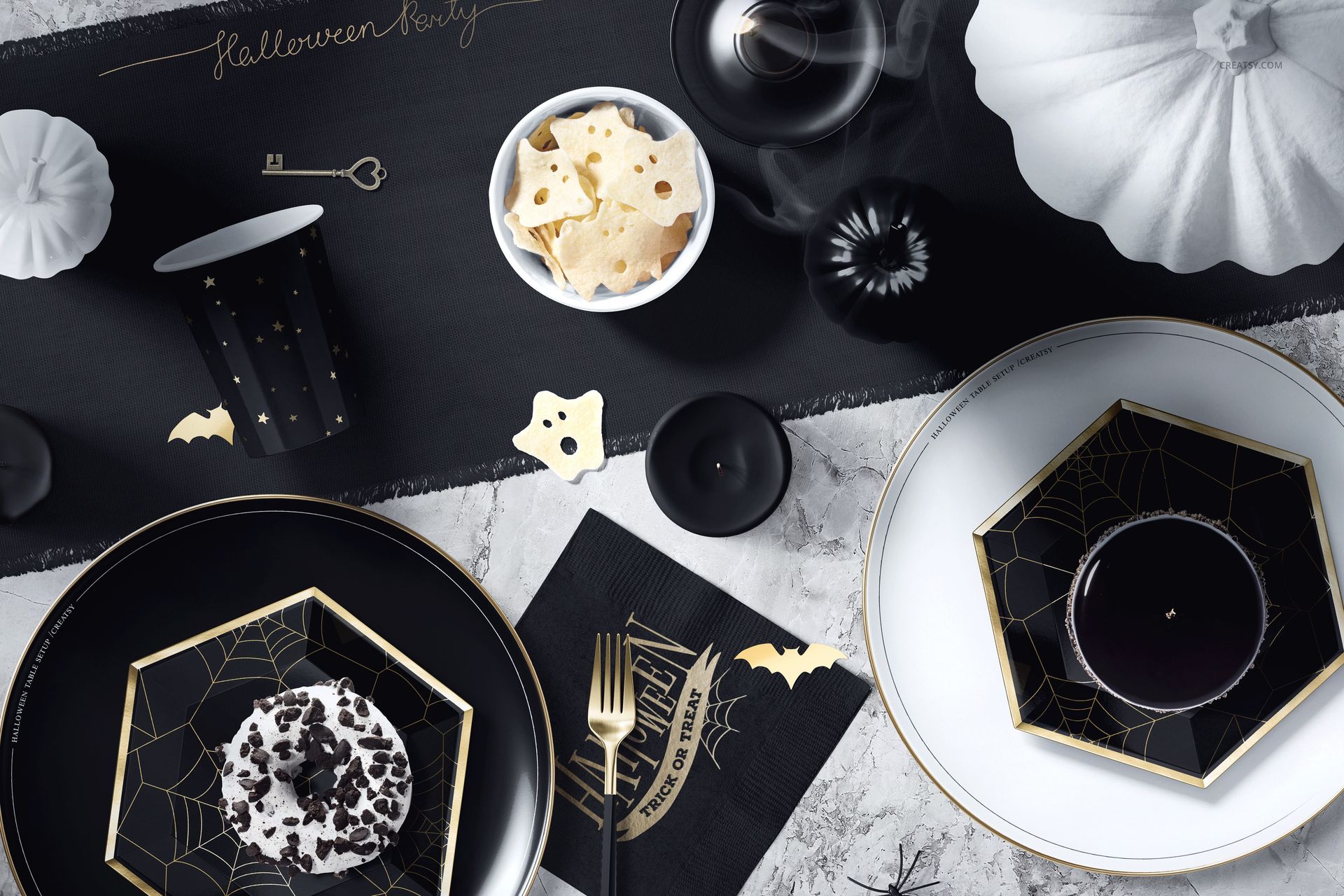 PSD mockup of a Halloween table scene with black and white dishes, spooky napkins, and ghost-shaped crackers.