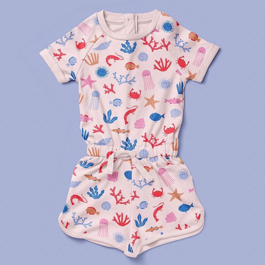Kids playsuit mockup featuring a short-sleeve cotton romper with a colorful sea life pattern on a soft purple background.