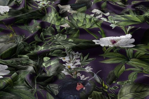 Tablecloth fabric mockup featuring a dark purple background with green leaves and white flowers in a detailed pattern.
