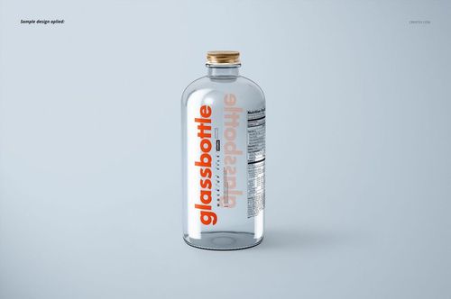 Glass bottle mockup with transparent body and metallic cap, orange label design, displayed against pale backdrop.