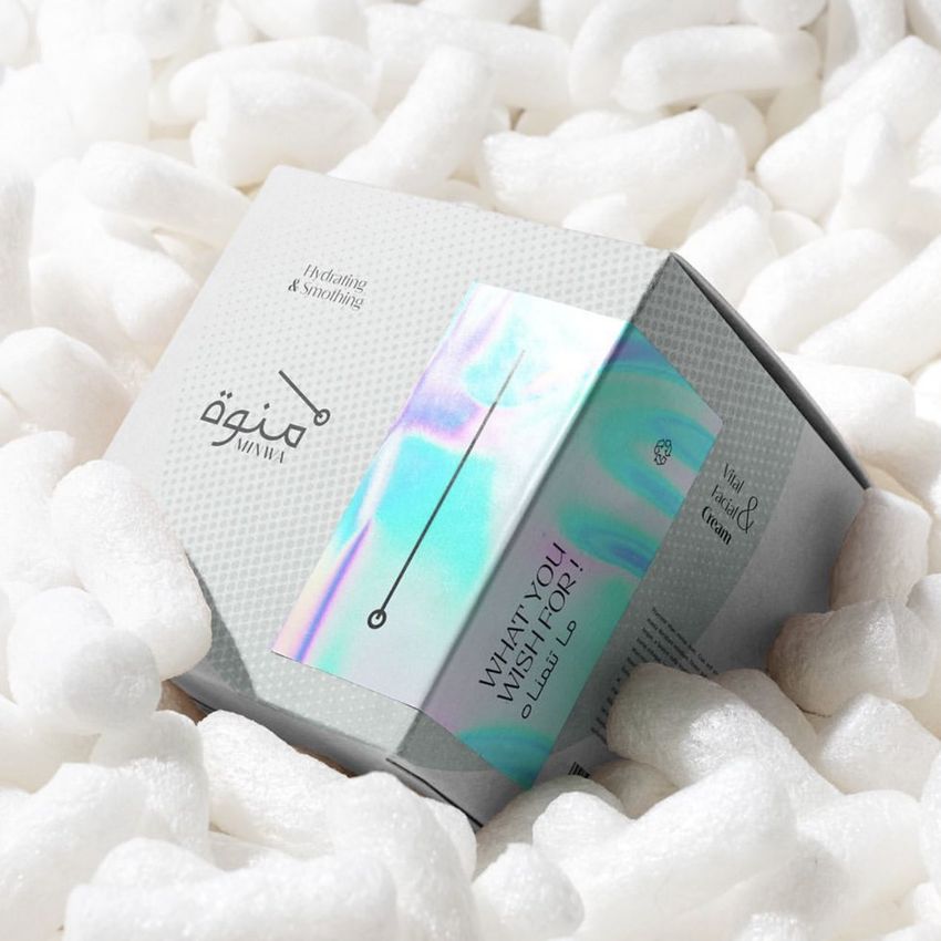 Packaging and wrapping mockup featuring a square box with a holographic sticker, surrounded by white packing peanuts.