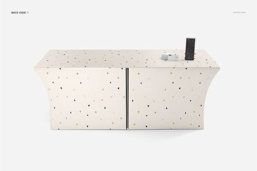 Back view of a fitted tablecloth mockup featuring scattered triangle shapes in pastel colors, with props on top.