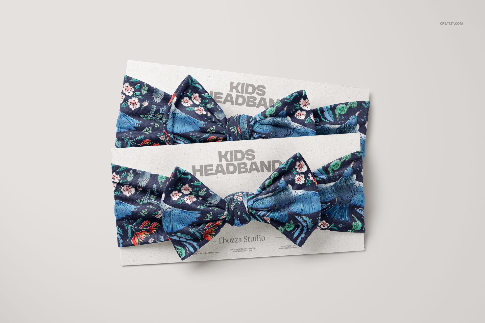 PSD mockup showing two kids bow tie headbands with blue and multicolor designs on branded packaging cards.