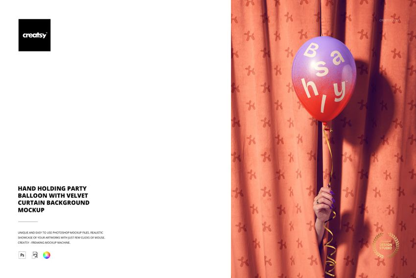 Hand holding a round red party balloon with white letters in front of a peach velvet curtain, front view mockup.