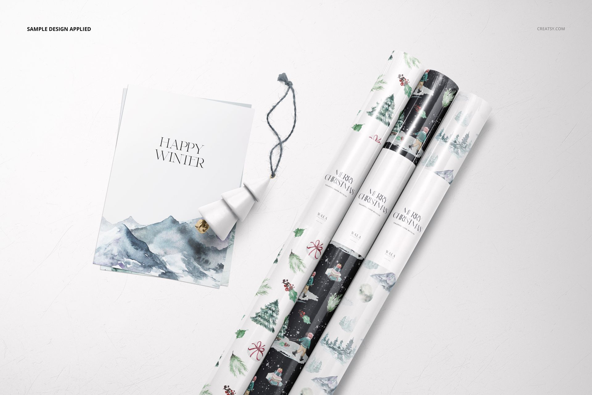 Gift wrapping paper mockup featuring three rolled sheets with festive designs, shown from a top view with seasonal props.