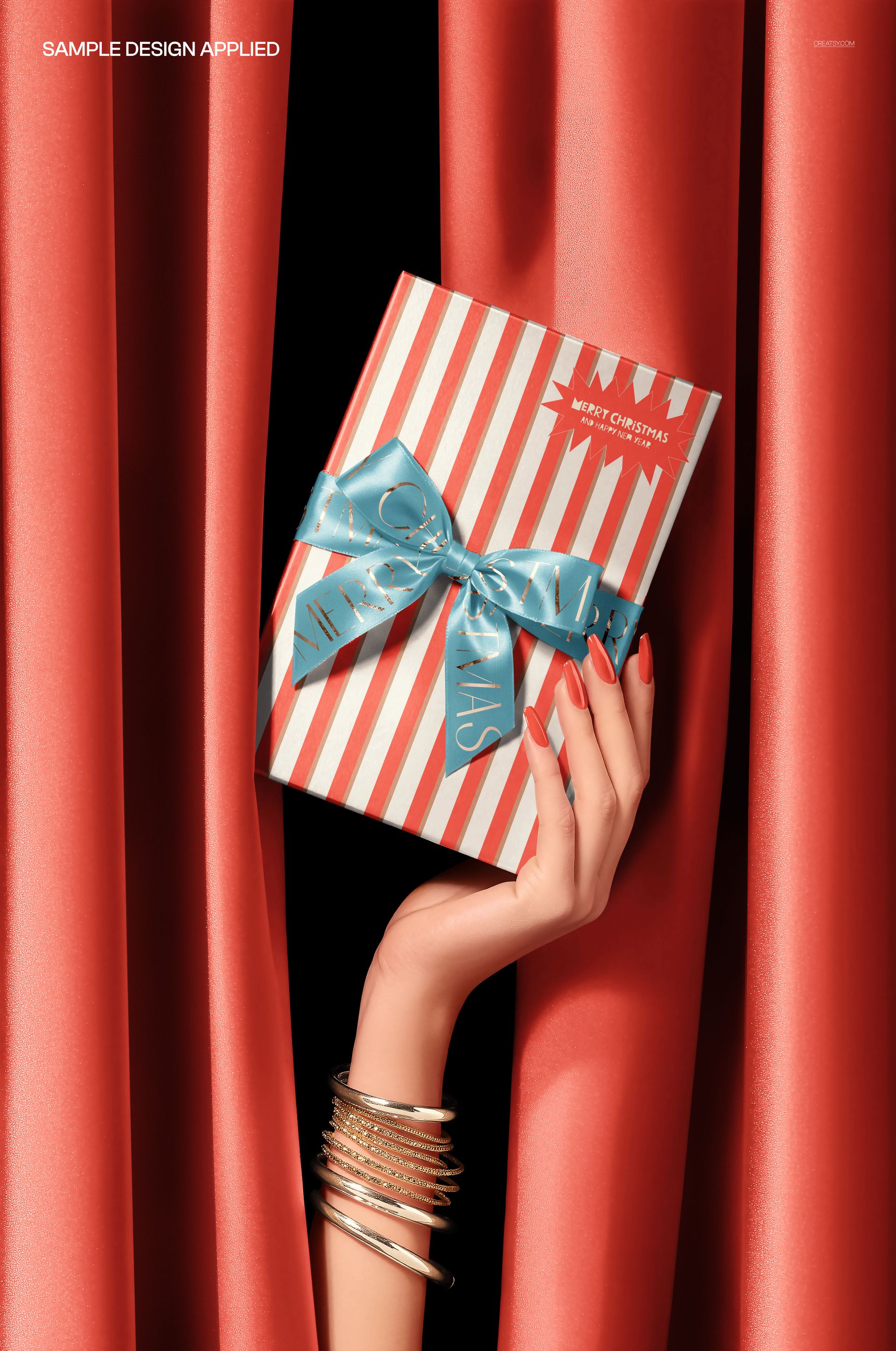 Hand holding a striped gift box with a blue ribbon behind red curtains, front view, elegant packaging mockup.