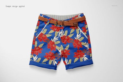 Kids shorts mockup with a brown woven belt, featuring a bold red floral pattern on a blue background, top view.