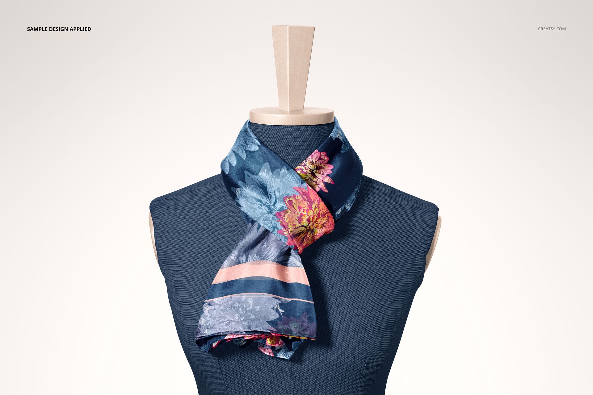 PSD mockup of a habotai silk scarf with colorful floral and stripe design wrapped on a dress form, front angle.