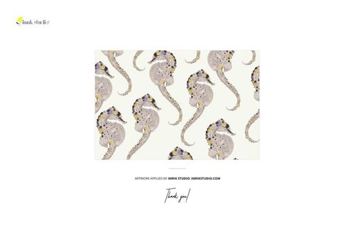 Seahorse-patterned fabric displayed flat with twine on coastal volcanic rocks, shown in a PSD mockup scene.