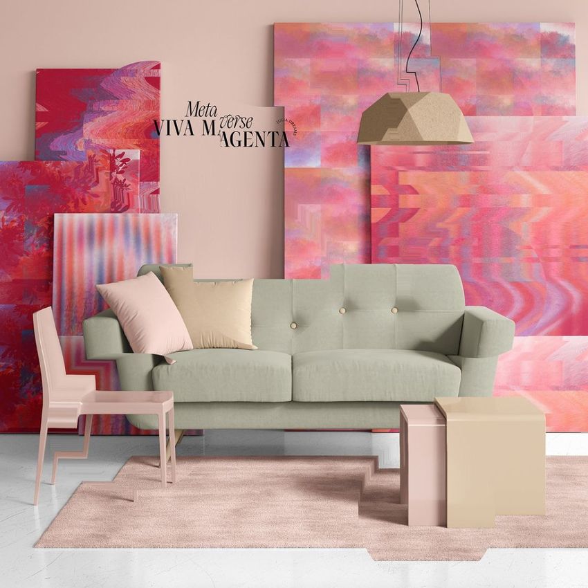 Modern sofa mockup in a living room scene with pastel cushions, pink rug, and abstract magenta artwork on the wall.
