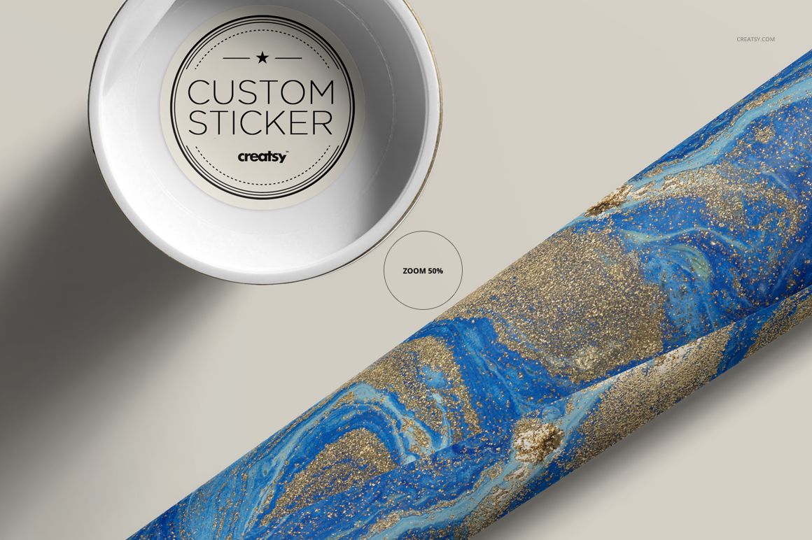 Mailing tube mockup featuring a close-up of a blue and gold marbled pattern, with a round custom sticker on the cap.