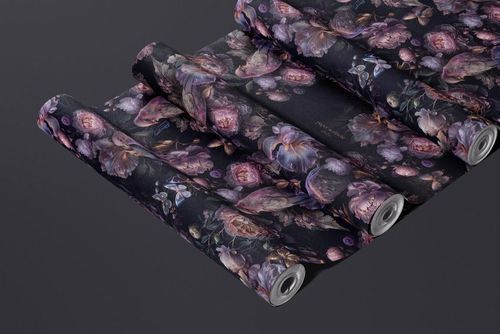 Rolled non-woven vinyl wallpaper mockup featuring a purple and pink floral design on a dark surface.