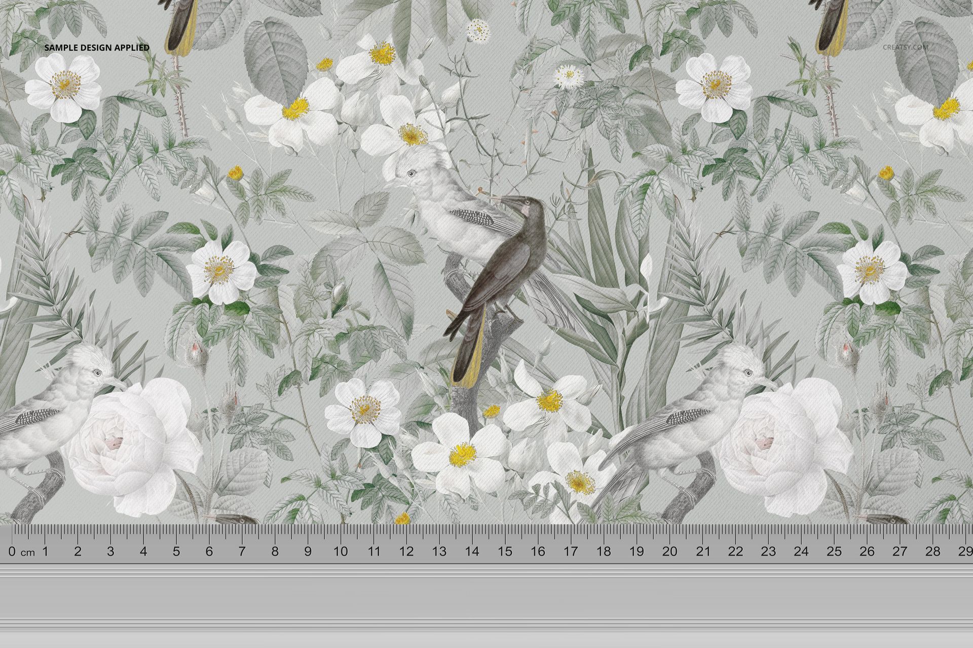 Polyester fabric mockup featuring a botanical pattern with birds, white flowers, and green leaves, shown with ruler scale.