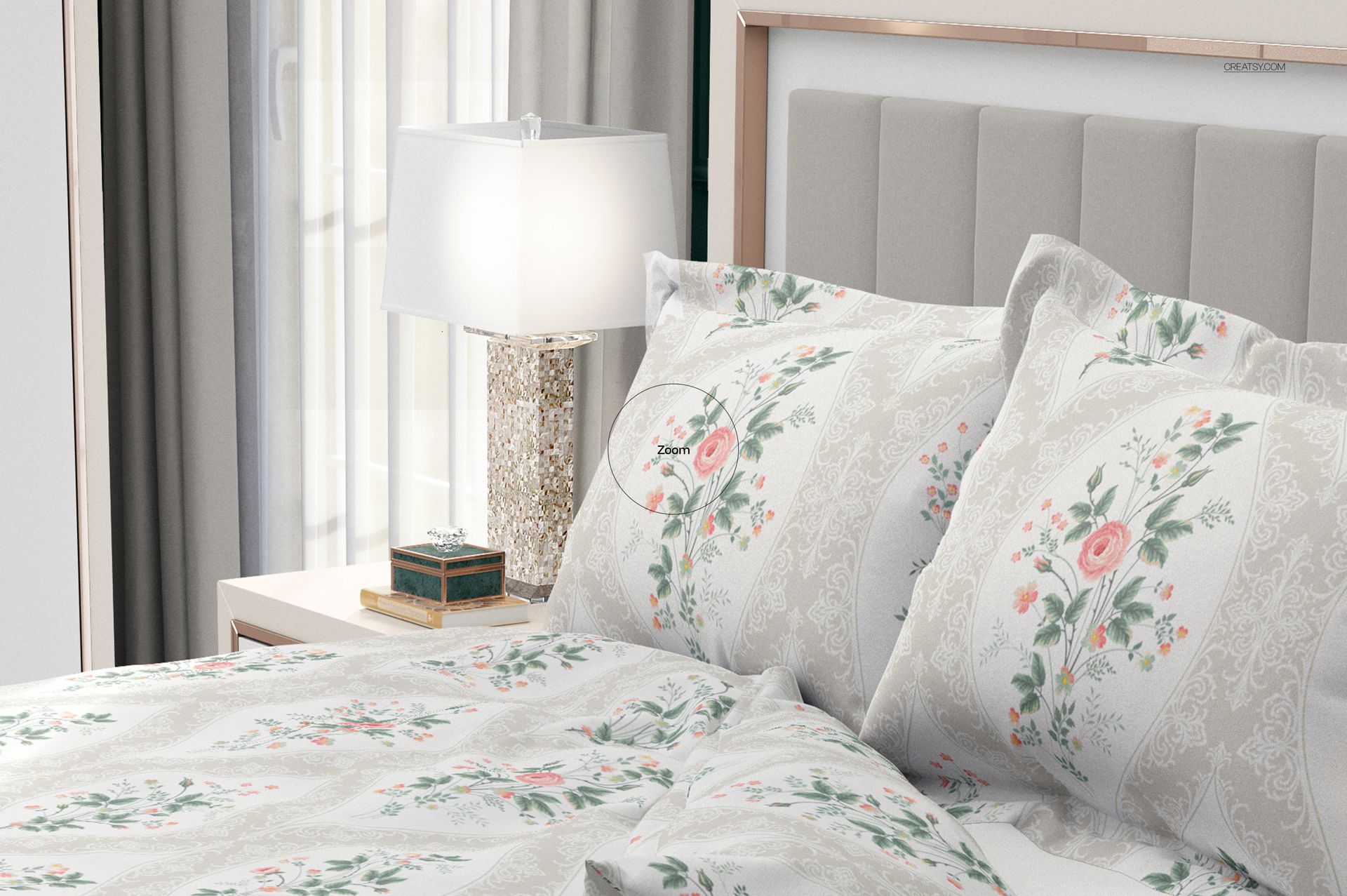 Close-up of a bedding mockup with flanged pillows, showing light-colored fabric with elegant floral designs in a bedroom.