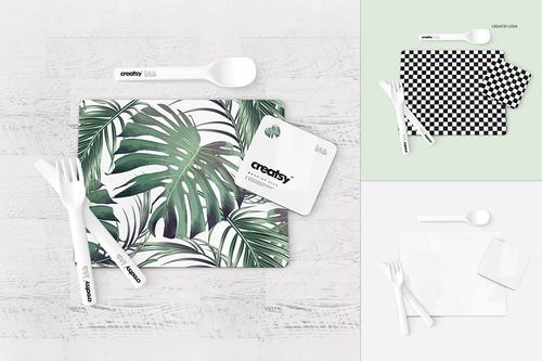 Placemat and coaster set mockup featuring a tropical leaf pattern, shown with white utensils on a light wooden surface.