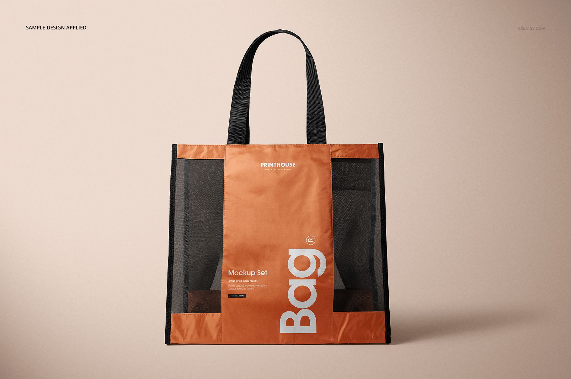 Front view of a mesh shopping tote bag mockup featuring black mesh sides and an orange center panel on a beige surface.