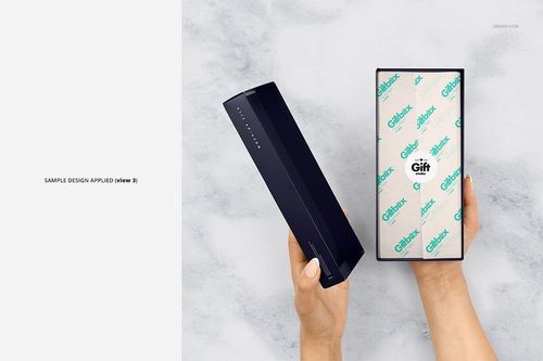 PSD mockup showing a person holding a dark rectangular gift box with custom tissue paper lining the interior.