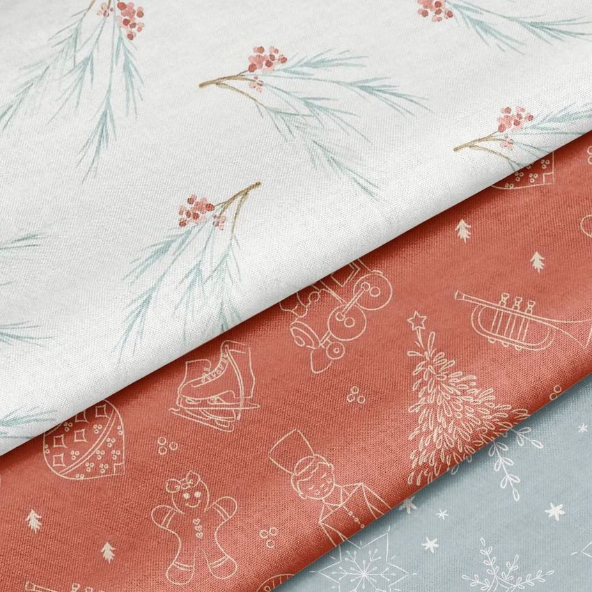 Cotton fabric mockup featuring three folded pieces with holiday-themed patterns in white, terracotta, and light blue tones.