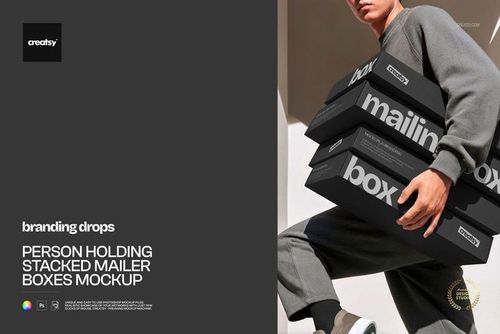 PSD mockup featuring a person holding multiple black mailer boxes with prominent white lettering outdoors.
