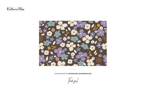 Angled view of a jersey fabric mockup featuring a floral pattern in white, purple, and blue on a brown background.