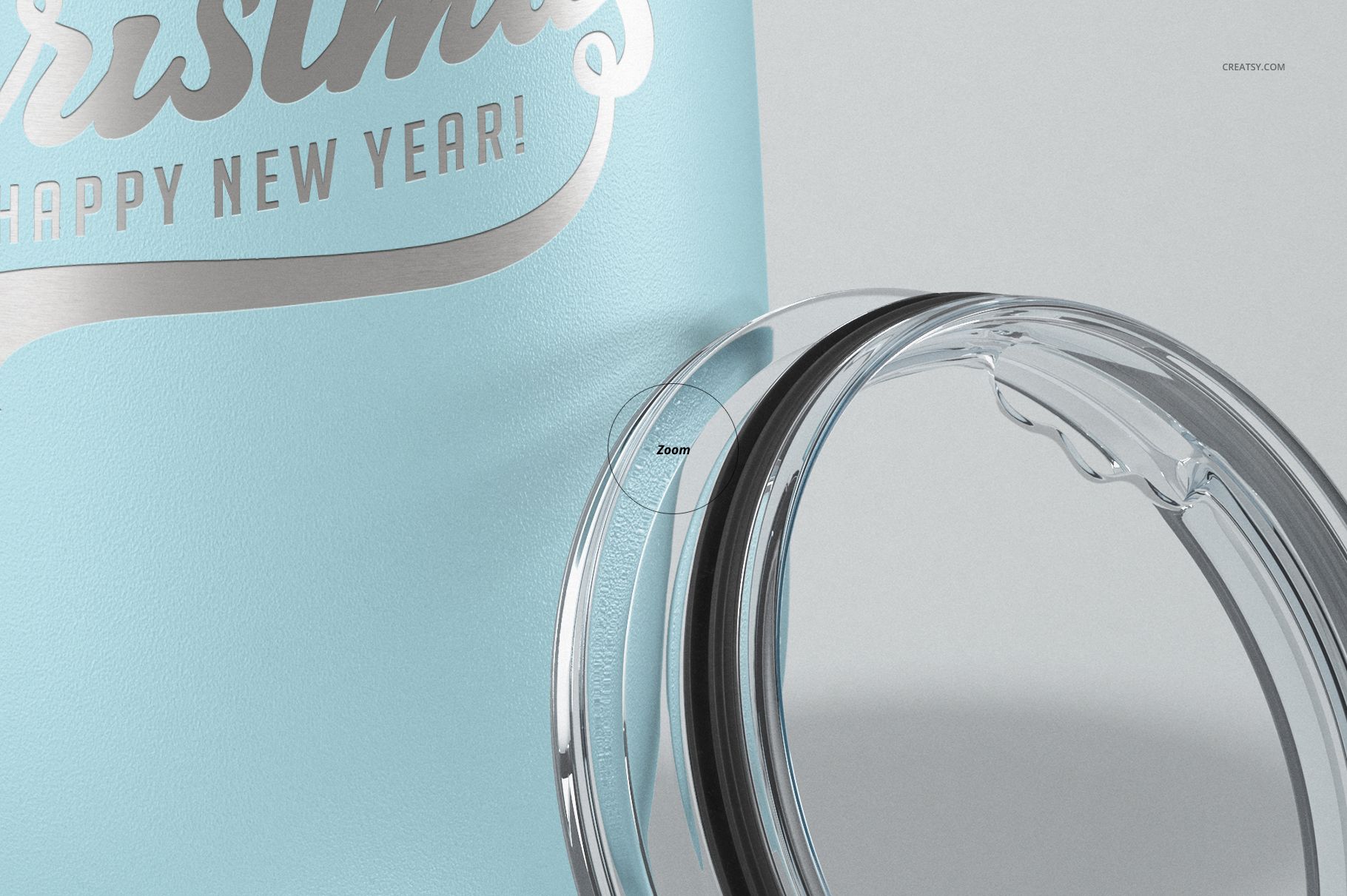 Close-up of a light blue stemless wine cup with metallic text and a transparent plastic lid beside it.