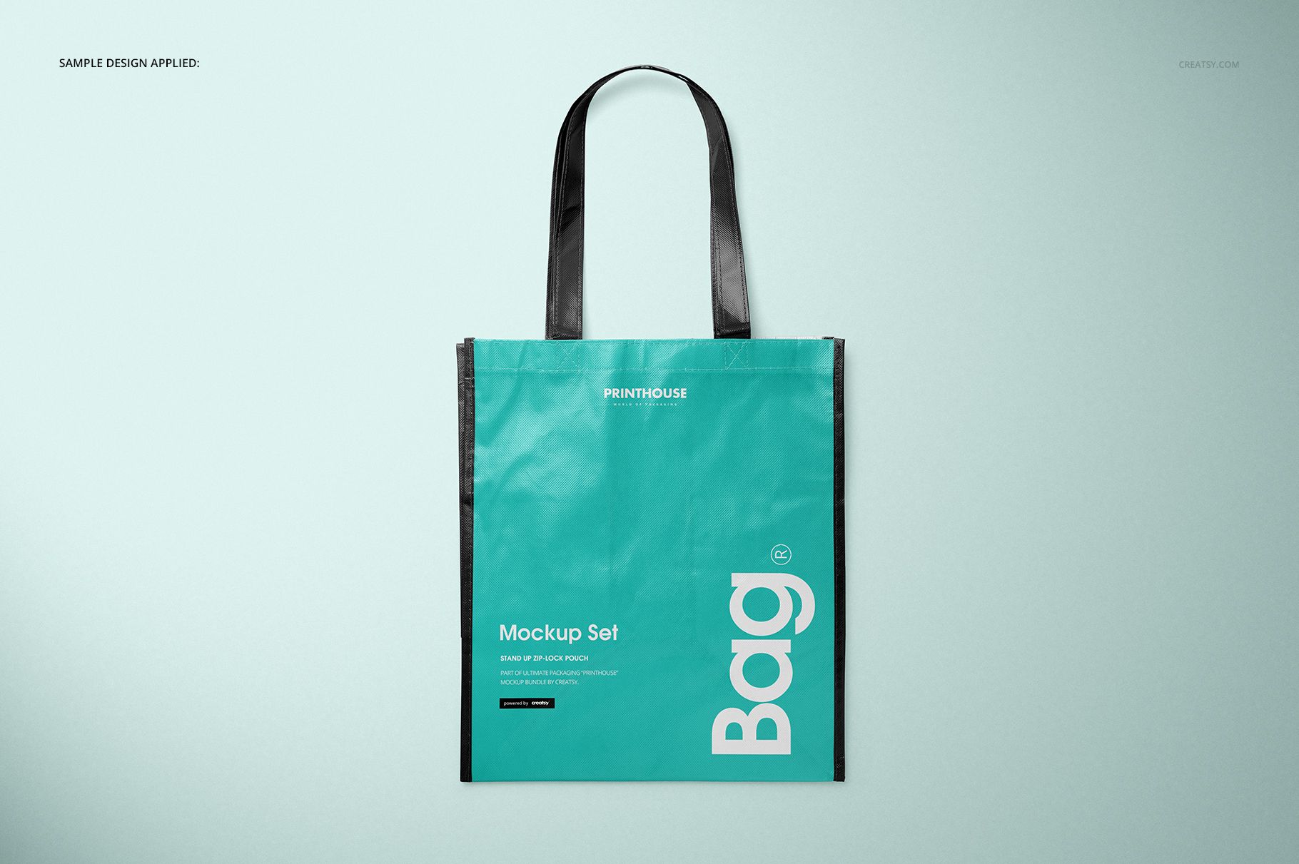 Front view of a laminated non-woven tote bag mockup with black handles and teal body on a light background.