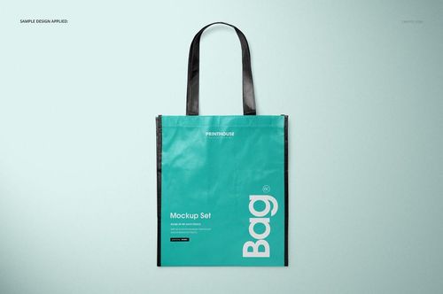 Front view of a laminated non-woven tote bag mockup with black handles and teal body on a light background.