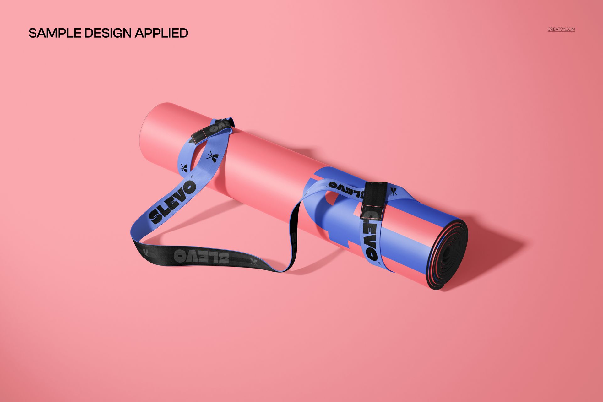 PSD mockup of a rolled PU yoga mat with a strap, featuring pink and blue tones, displayed on a pink surface.