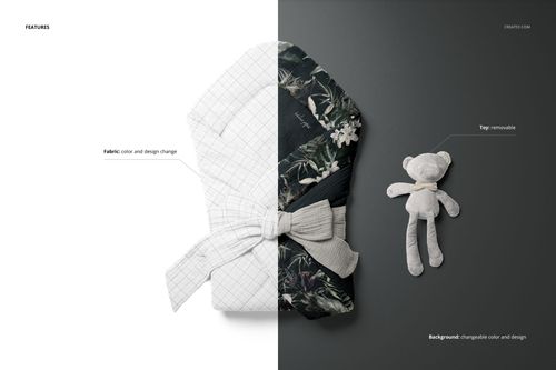 PSD mockup of a muslin baby wrap shown from above, featuring a bow tie detail and a removable teddy bear on a gray surface.