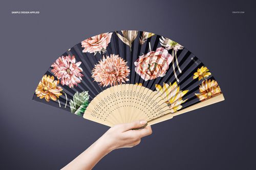Front view of a fabric hand fan mockup with a wooden handle and vibrant flower designs on dark fabric.