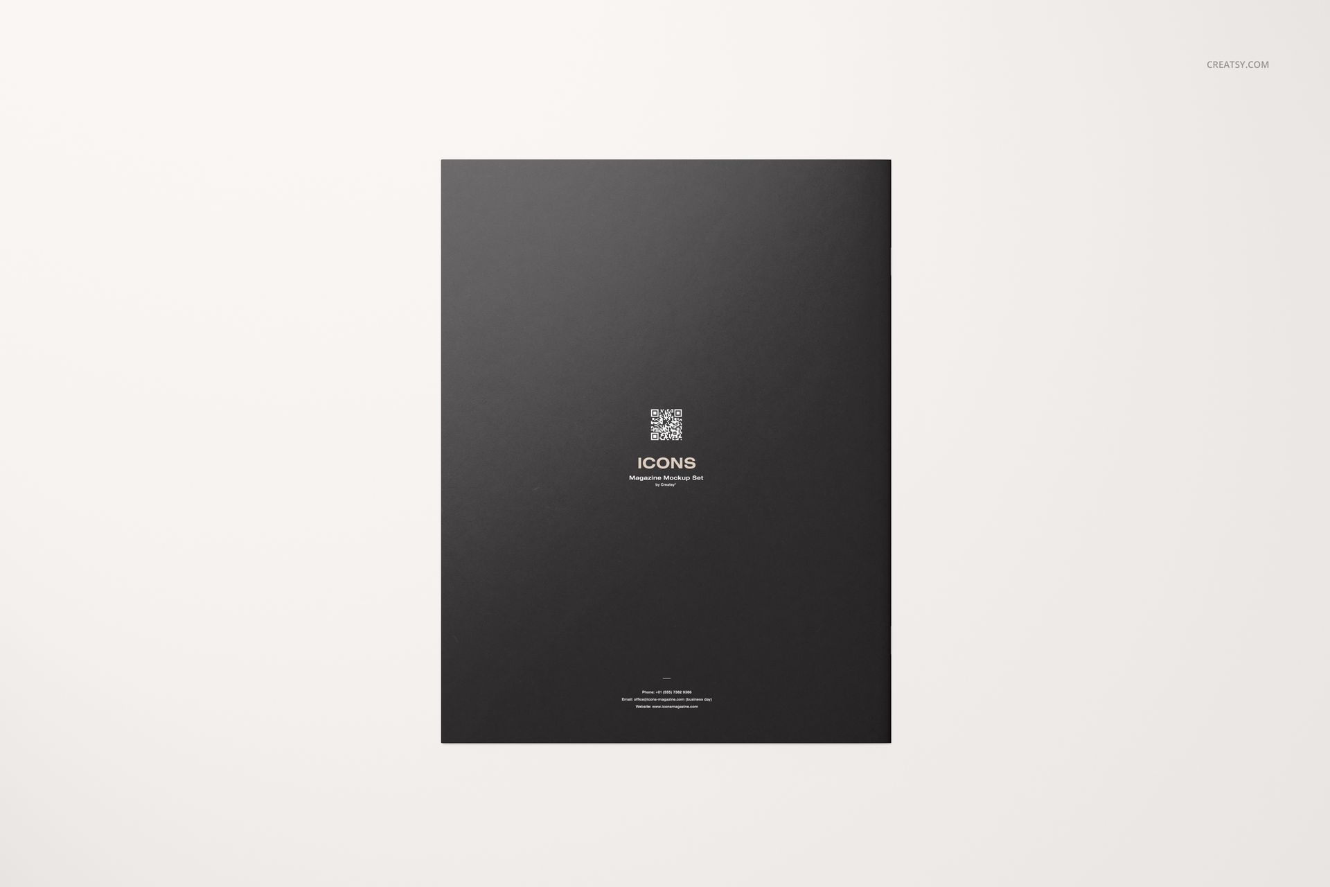 Top-down perspective of an 8.5x11 magazine mockup featuring a plain black cover and simple white text.